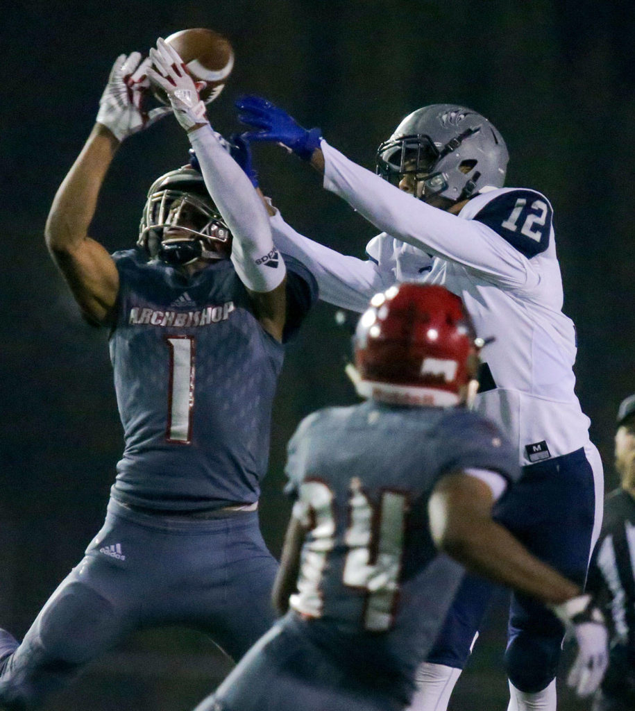 Archbishop Murphy’s Kyler Gordon (left) breaks up a pass intended to River Ridge’s Lamar Campbell with Archbishop Murphy’s Freddy Girault (24) looking on during a 2A state playoff game on Nov. 10, 2017, at Goddard Stadium in Everett. (Kevin Clark / The Herald)
