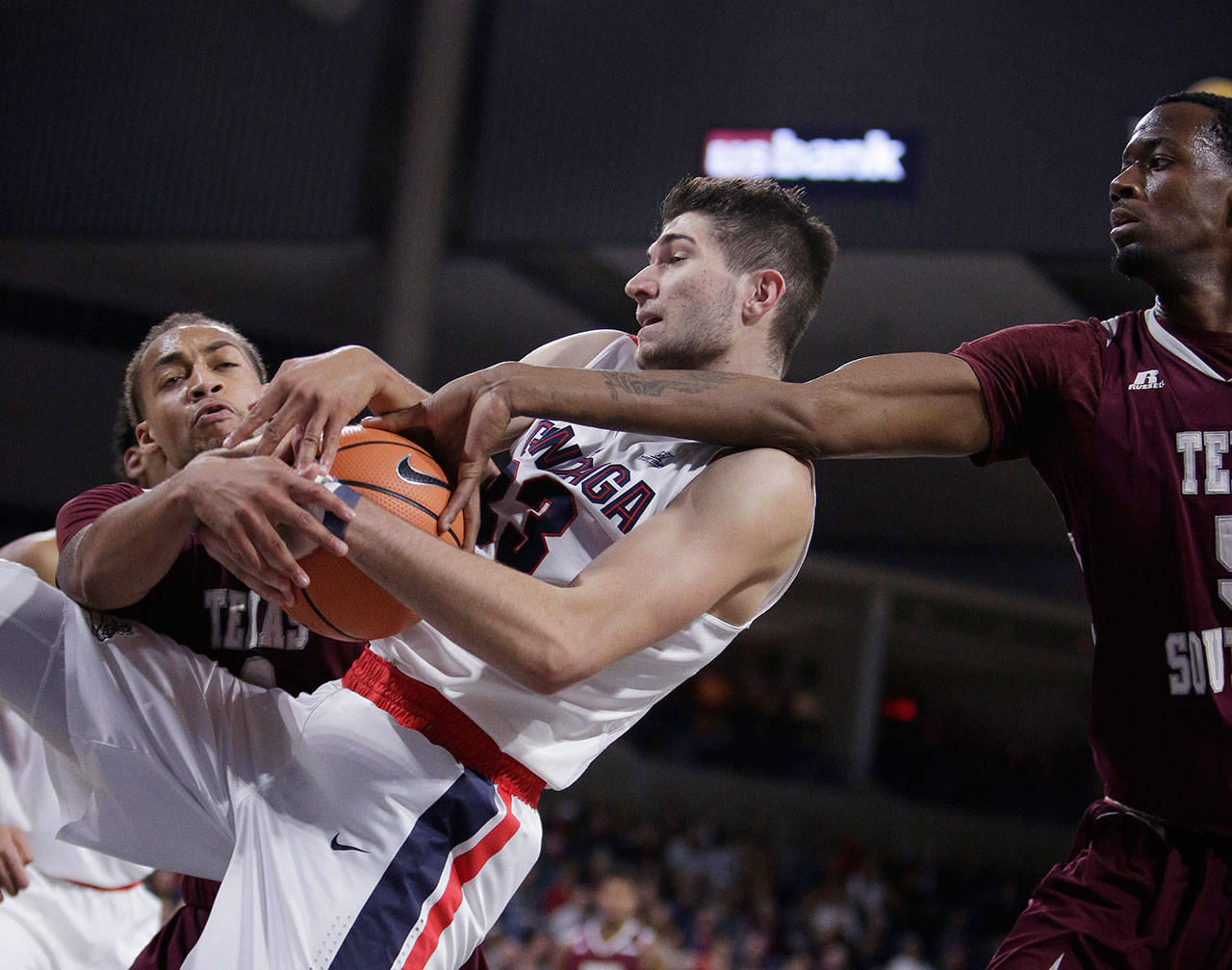 Gonzaga forward Killian Tillie (center) goes after a rebound against Texas Southern forward Kevin Scott (left) and center Trayvon Reed during the first half of a game Nov. 10, 2017, in Spokane. (AP Photo/Young Kwak)