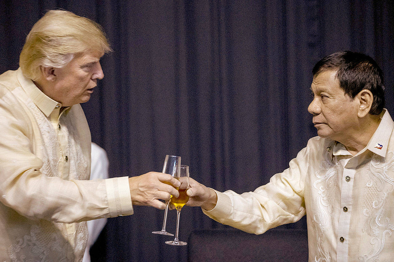 President Donald Trump toasts Philippines President Rodrigo Duterte (right) at an ASEAN Summit dinner at the SMX Convention Center on Sunday in Manila, Philippines. (AP Photo/Andrew Harnik)