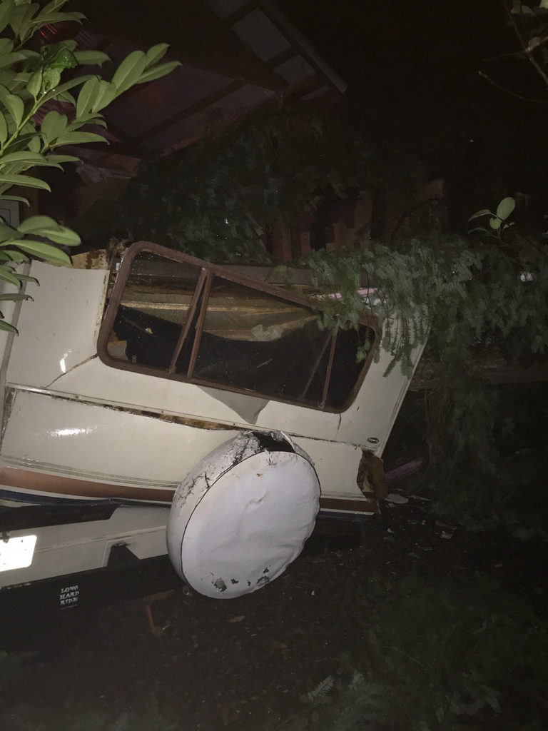 A falling tree struck the back of an RV parked next to a residence in Arlington on Monday, hitting an occupant. The man was able to get himself out of the RV and was transported to Cascade Valley Hospital by Arlington Fire with non-life threatening injuries. (Arlington Fire)
