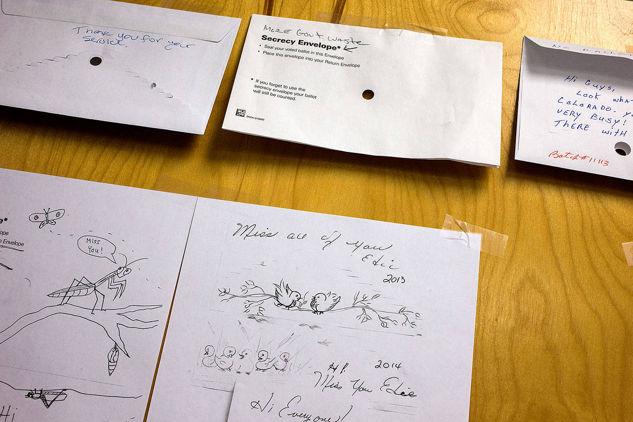 On a door of the center hang drawings found on ballots and secrecy envelopes that range from scenes of birds to social statements. (Andy Bronson / The Herald)