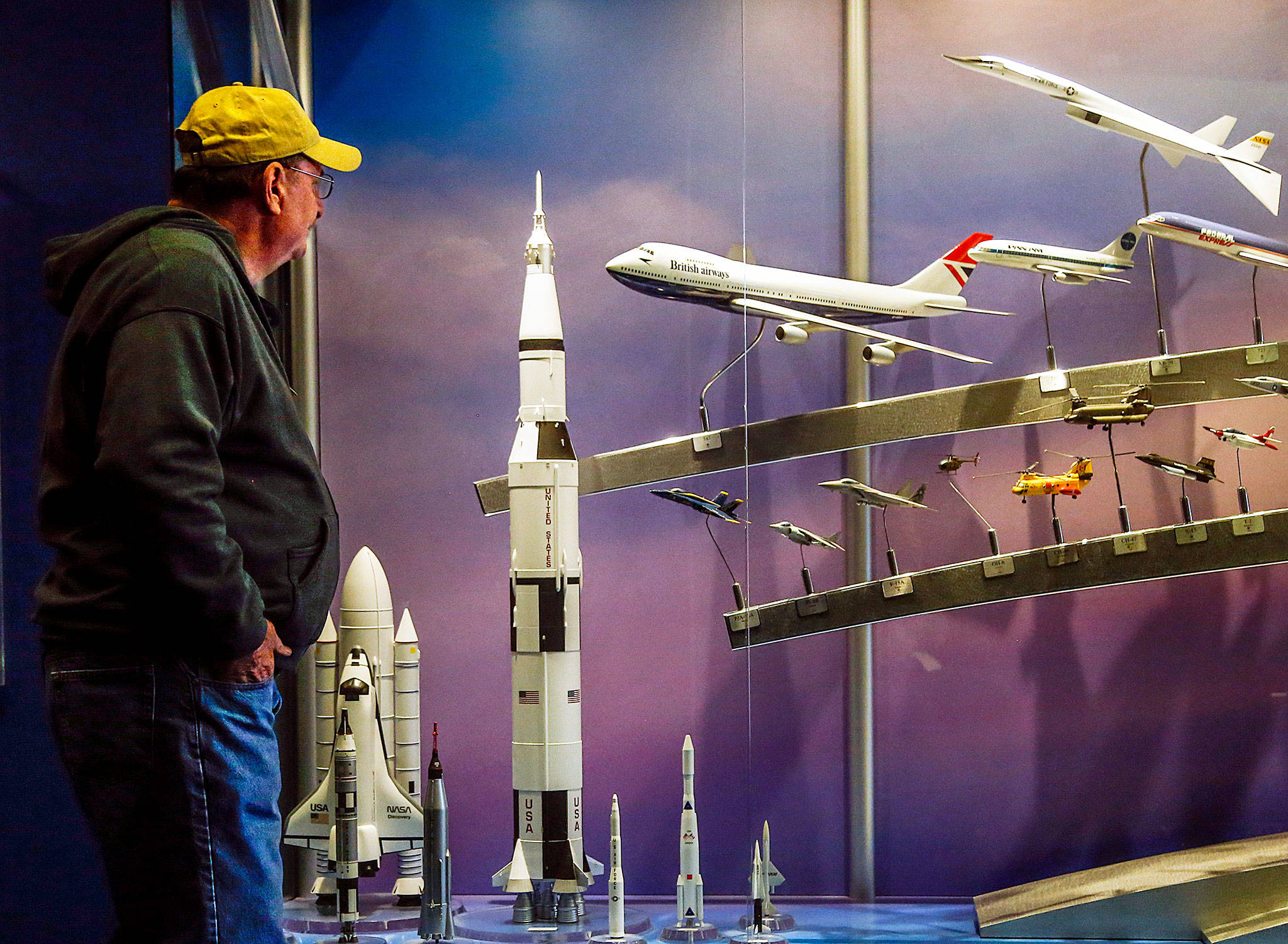 At the Future of Flight Aviation Center, a visitor pauses at a display case where a model of a British Airways 747 (center) is exhibited next to models of rockets, spaceships and supersonic aircraft. By the end of this year, the 747 will no longer be flown by any U.S. airlines on passenger flights. (Dan Bates / The Herald)