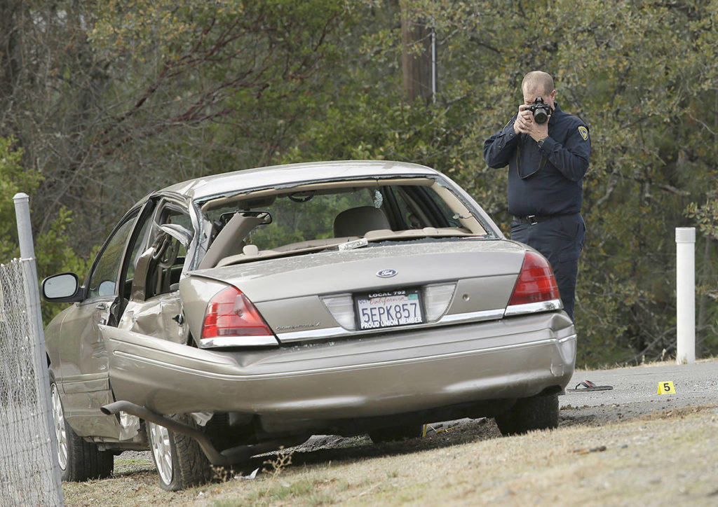 A California Highway patrol officer photographs a vehicle involved in a deadly shooting rampage at the Rancho Tehama Reserve, near Corning, California on Tuesday. (AP Photo/Rich Pedroncelli)

