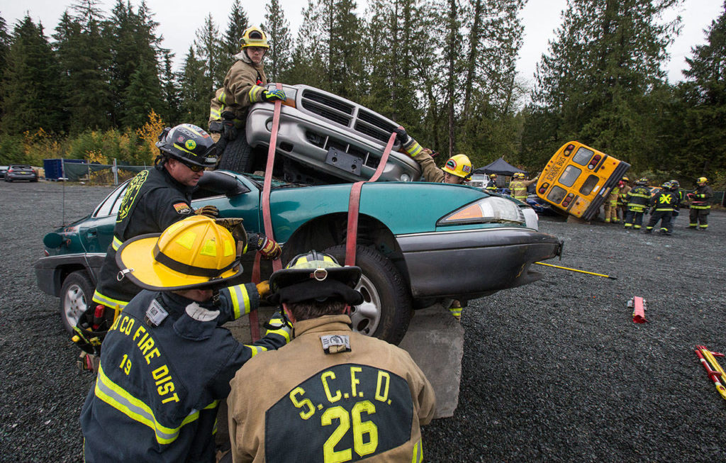 Snohomish County area fire departments practice multi-agency response training for vehicle accidents. (Andy Bronson / The Herald)
