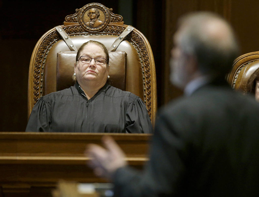 Washington state Supreme Court Chief Justice Mary Fairhurst listens as Alan Copsey, deputy solicitor general in the Washington state attorney general’s office, speaks Oct. 24 during a Washington Supreme Court hearing in Olympia. (AP Photo/Ted S. Warren, file)
