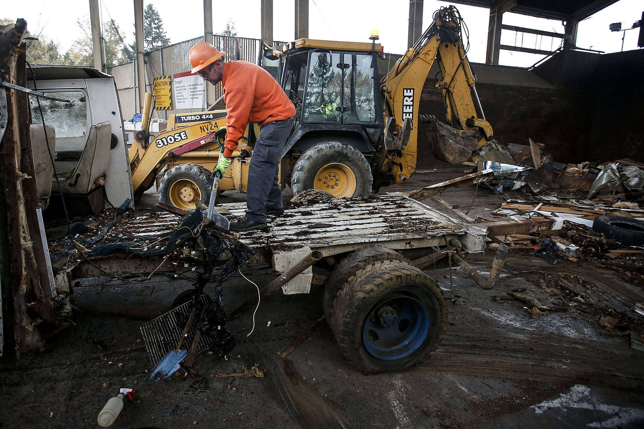 Greg Mackie shovels off the bed of what used to be an RV at the Cathcart transfer station on Thursday. The county’s Solid Waste Division’s Environmental Cleanup Team is working closely with other departments to help dispose of old abandoned trailers and RV’s. (Ian Terry / The Herald)
