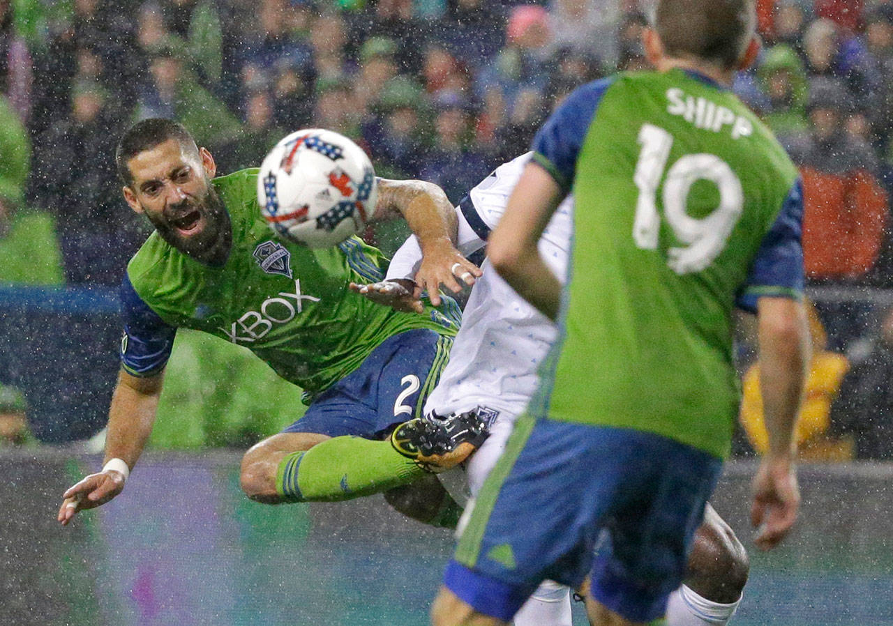Seattle Sounders forward Clint Dempsey (left) kicks the ball away from Vancouver Whitecaps midfielder Aly Ghazal during an MLS Western Conference semifinal match Nov. 3 in Seattle. (AP Photo/Ted S. Warren, file)