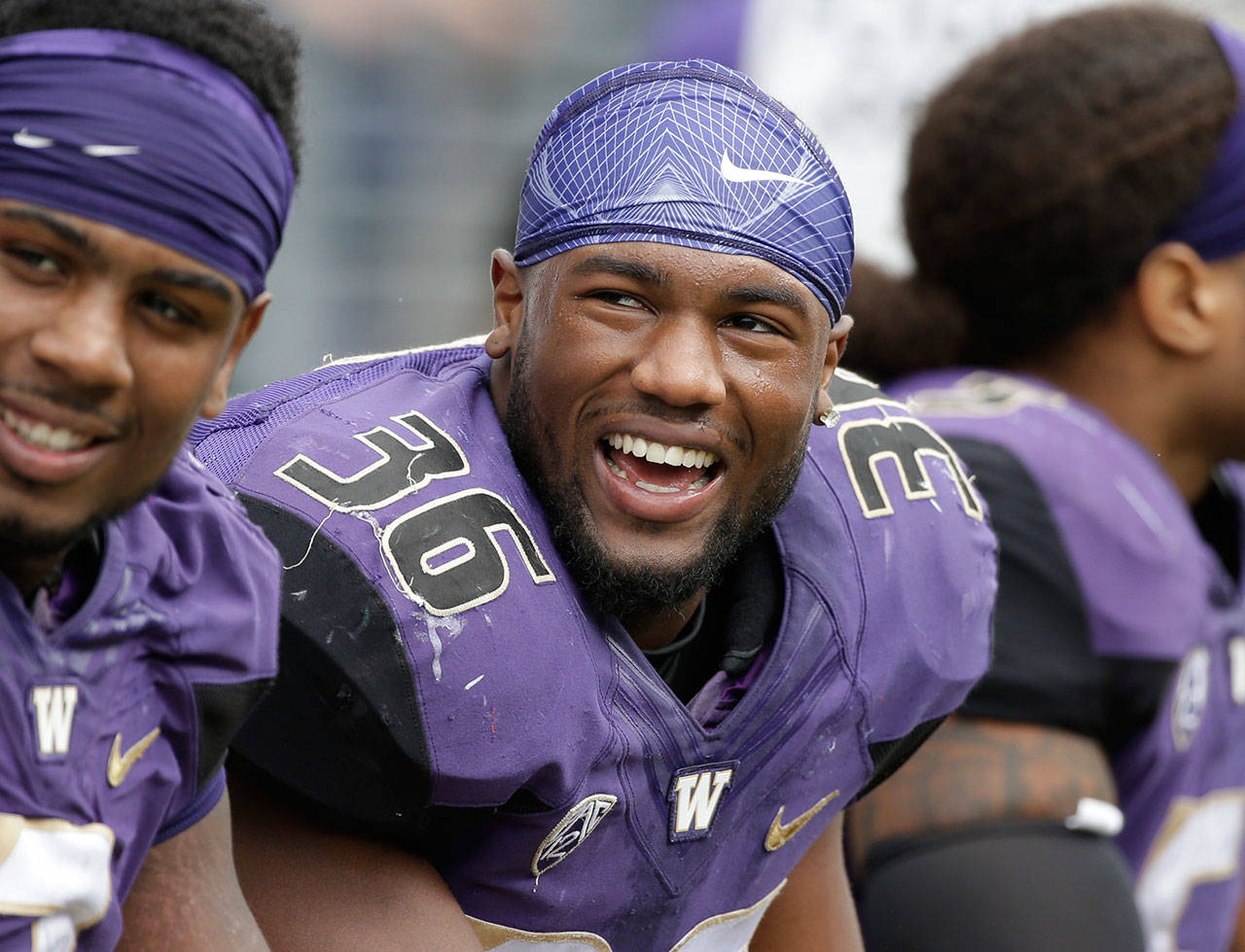 Washington linebacker Azeem Victor smiles on the sidelines during game in September of 2016. Victor, a preseason AP All-American, has been suspended by the team following his arrest over the weekend. (AP Photo/Elaine Thompson, File)