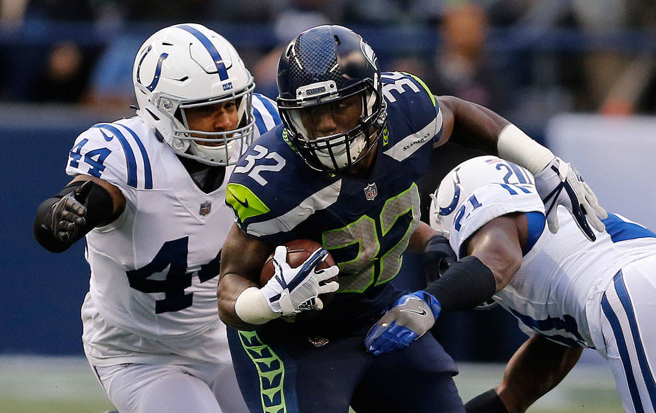 Seahawks running back Chris Carson (32) carries the ball during a game against the Colts on Oct. 1, 2017, in Seattle. (AP Photo/Stephen Brashear)