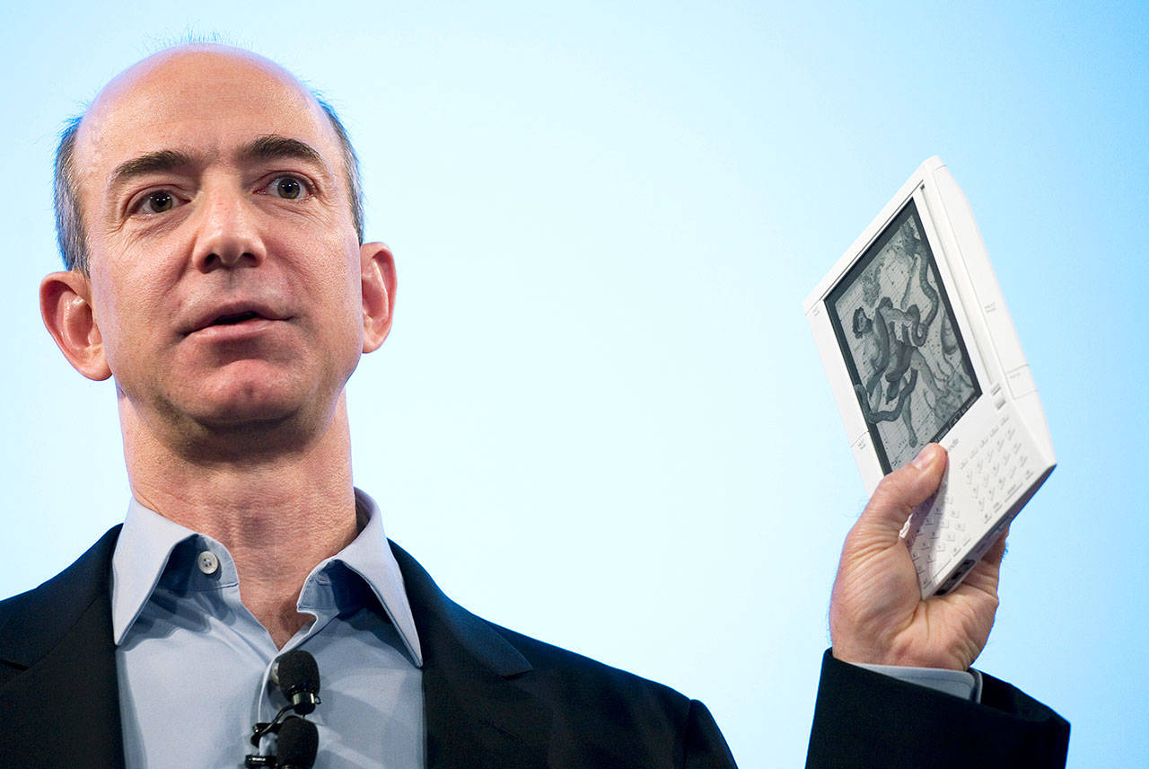 Jeff Bezos, founder and CEO of Amazon, introduces the first Kindle e-book reader at a news conference in New York on Nov. 19, 2007. (Associated Press archive)
