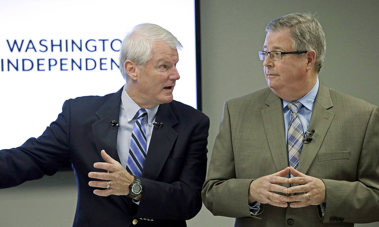 Former Democratic Congressman Brian Baird (left) and former Republican State Representative Chris Vance speak at a news conference Thursday in Seattle. (AP Photo/Elaine Thompson)