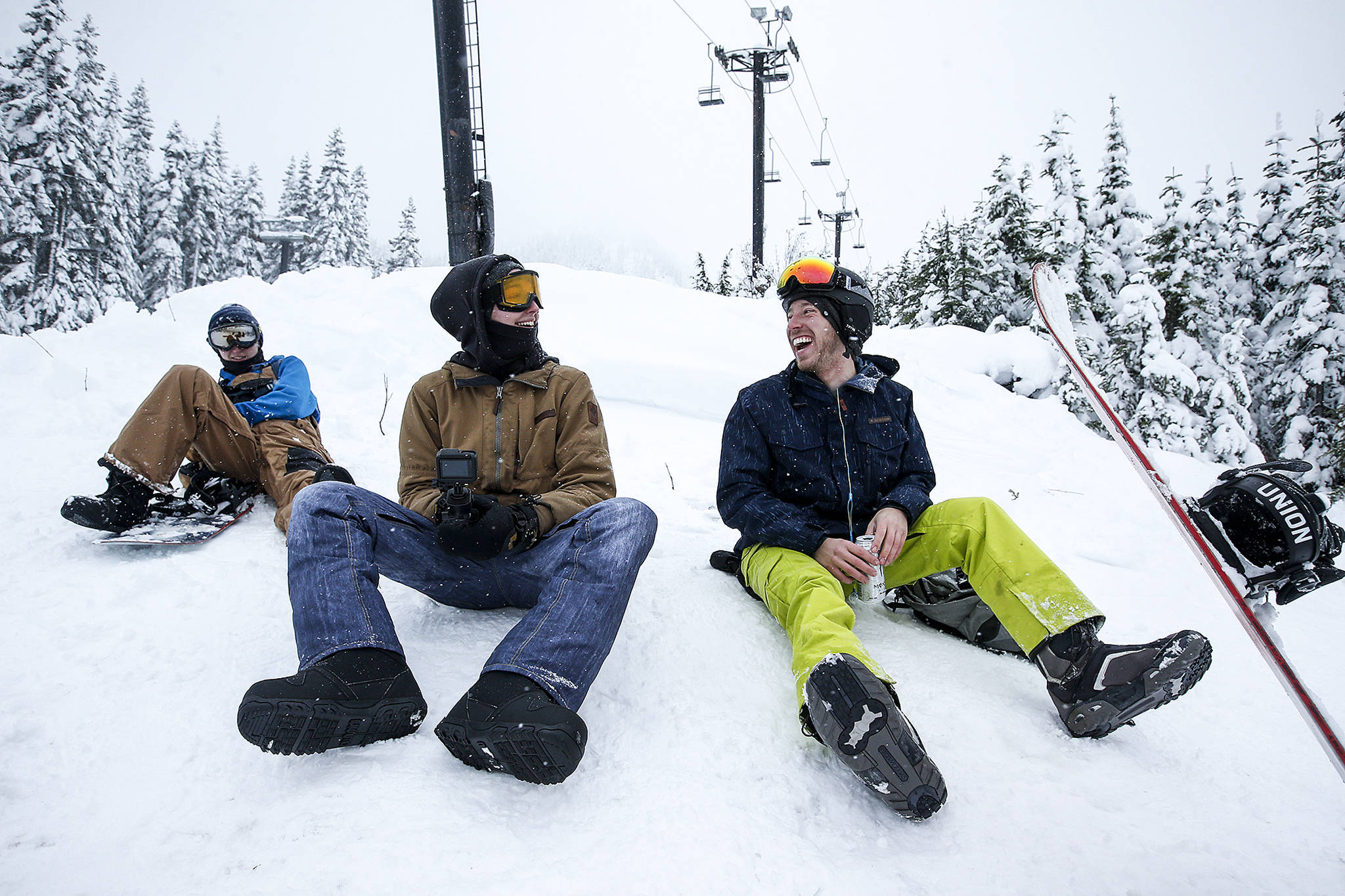 Brothers George (left) and William Mould, of Bothell, laugh with friend Erik Byland (right), of Woodinville, after a day of snowboarding at Stevens Pass on Thursday. The trio got on the road at 7 a.m. to be among of the first people to take a run on Stevens’ opening day. (Ian Terry / The Herald)