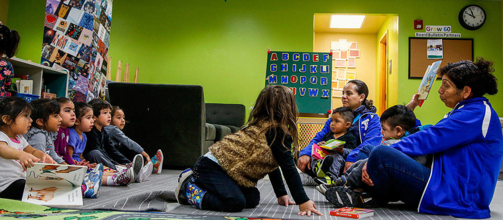 While their moms are taking the ESOL class in another room in the facility, a dozen or so 5-and-younger preschoolers recieve instruction from teacher Rosa Asturias (right) and teacher assistant Elsa Perez, who are both with the YMCA. (Dan Bates / The Herald)
