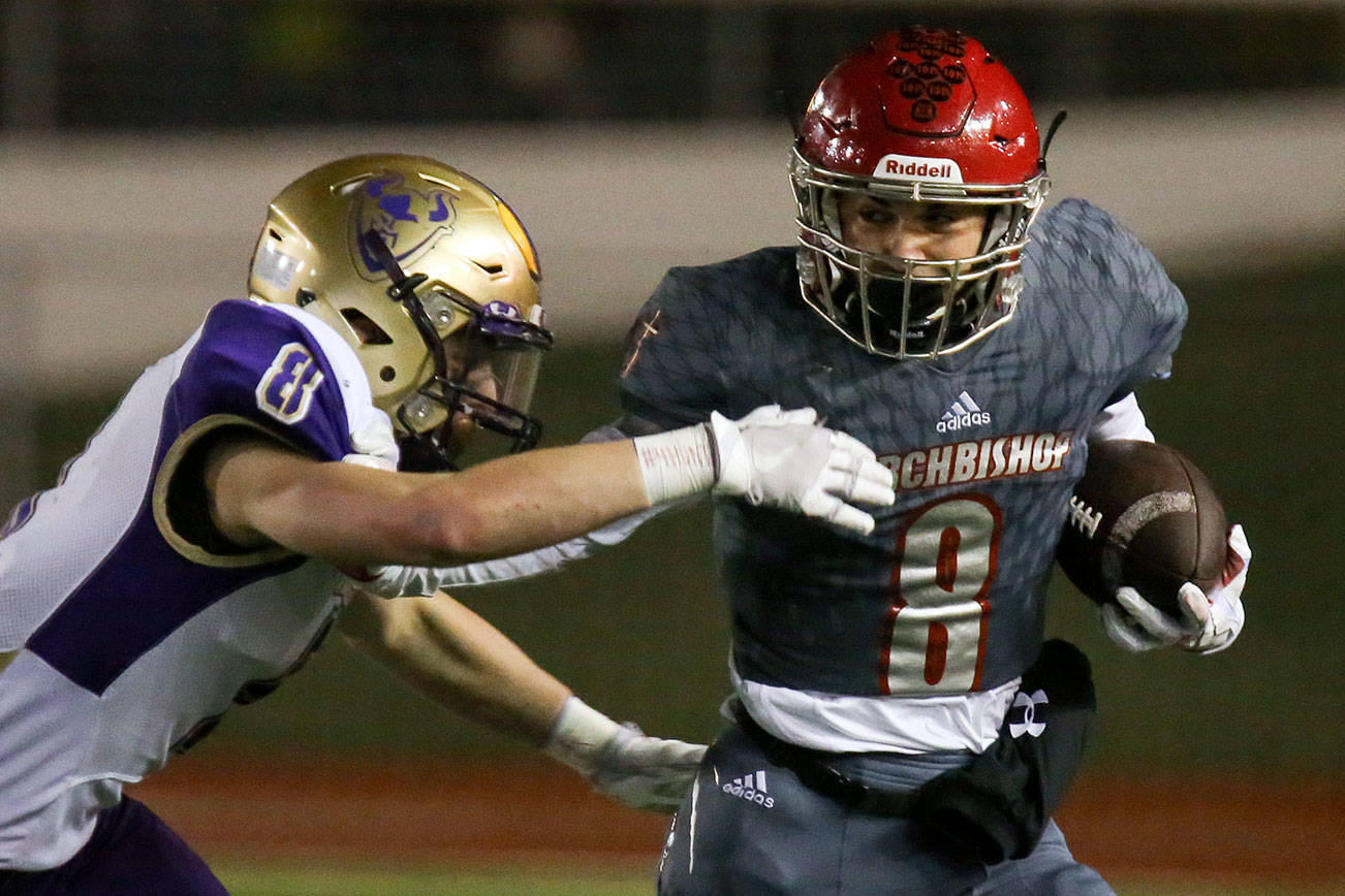 Archbishop Murphy’s Ray Pimentel, right, attempts a stiff arm on North Kitsap’s Kyle Green Friday night at Veterans Memorial Stadium in Snohomish on November 17, 2017. (Kevin Clark / The Herald)