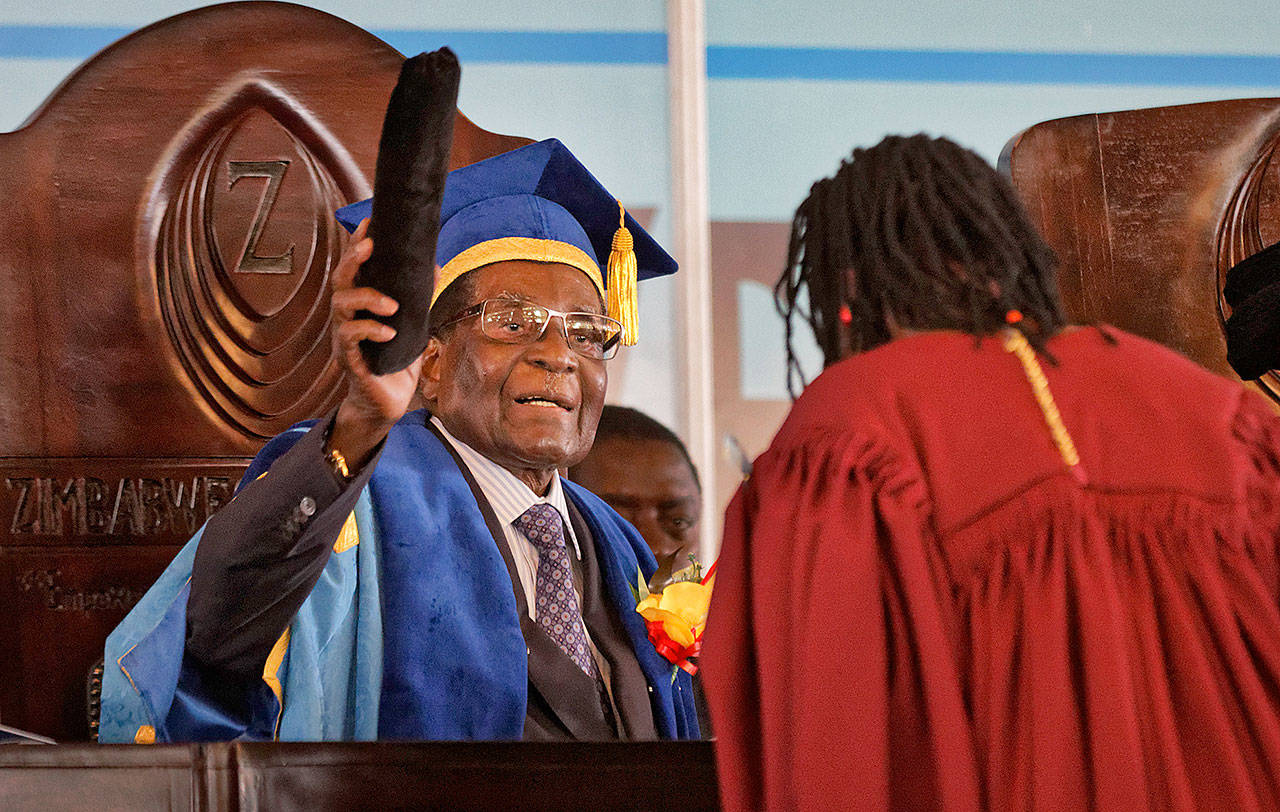 President Robert Mugabe confers awards for students as he presides over a graduation ceremony at Zimbabwe Open University on the outskirts of Harare, Zimbabwe, on Friday. (AP Photo/Ben Curtis)