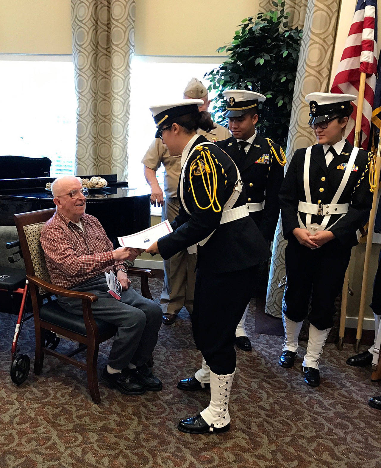 The Everett High School Navy Junior ROTC presents U.S. Army veteran Robert “Bob” Erickson with a certificate of appreciation during a visit to Brookdale Everett in honor of Veterans Day. (Contributed photo)
