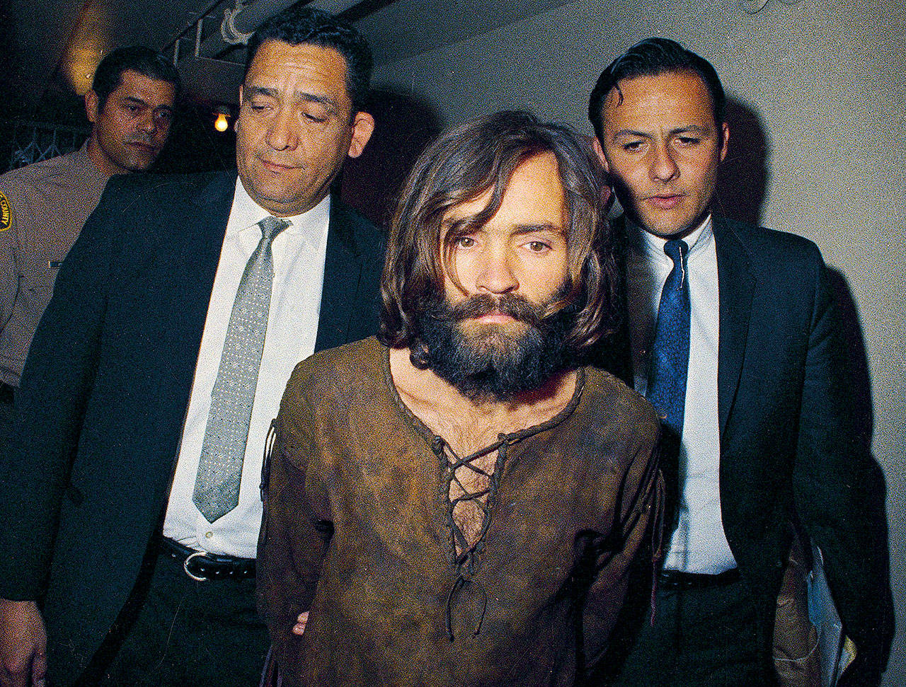 Charles Manson is escorted to his arraignment on conspiracy-murder charges in connection with the Sharon Tate murder case in 1969. Manson died on Sunday. He was 83. (AP Photo, File)