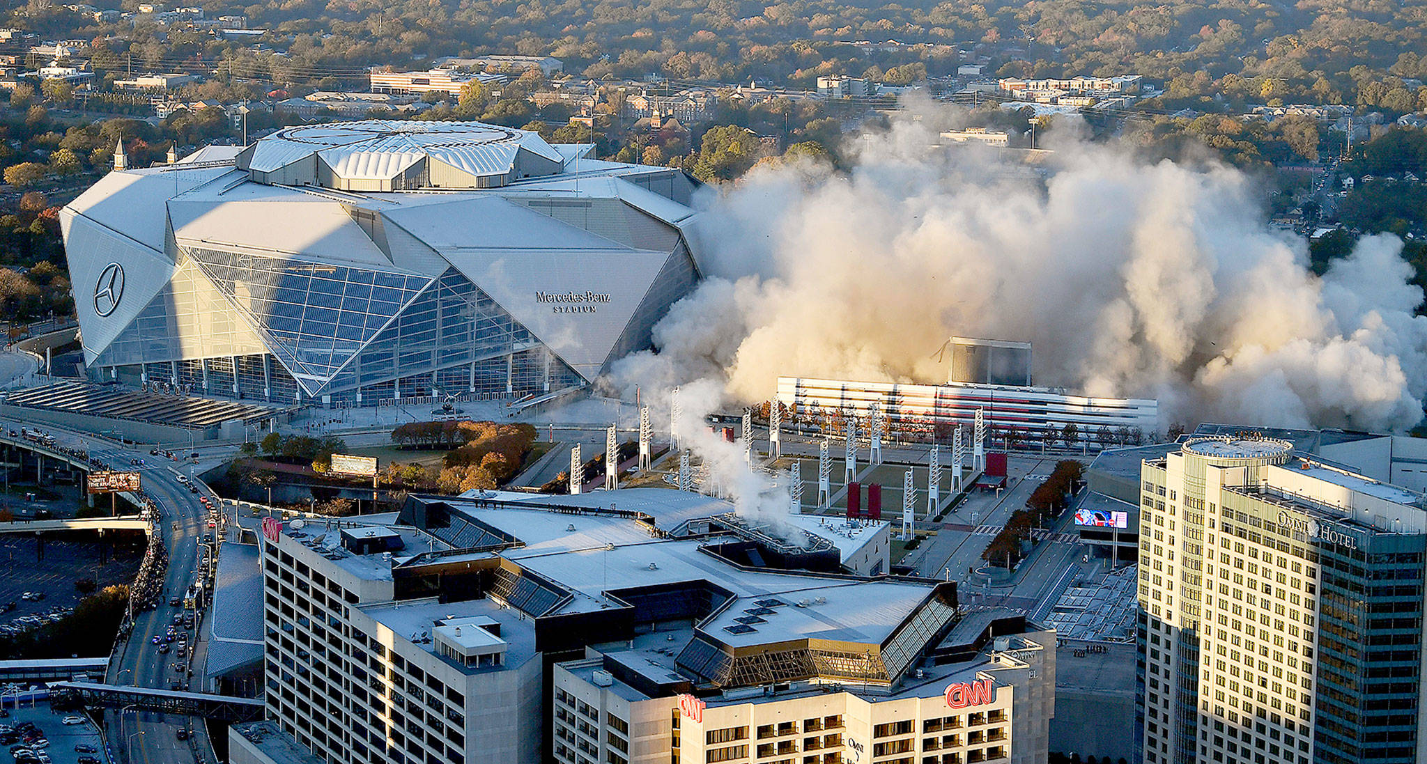 The Georgia Dome is destroyed in a scheduled implosion next to its replacement, the Mercedes-Benz Stadium (left), on Monday. (AP Photo/Mike Stewart)