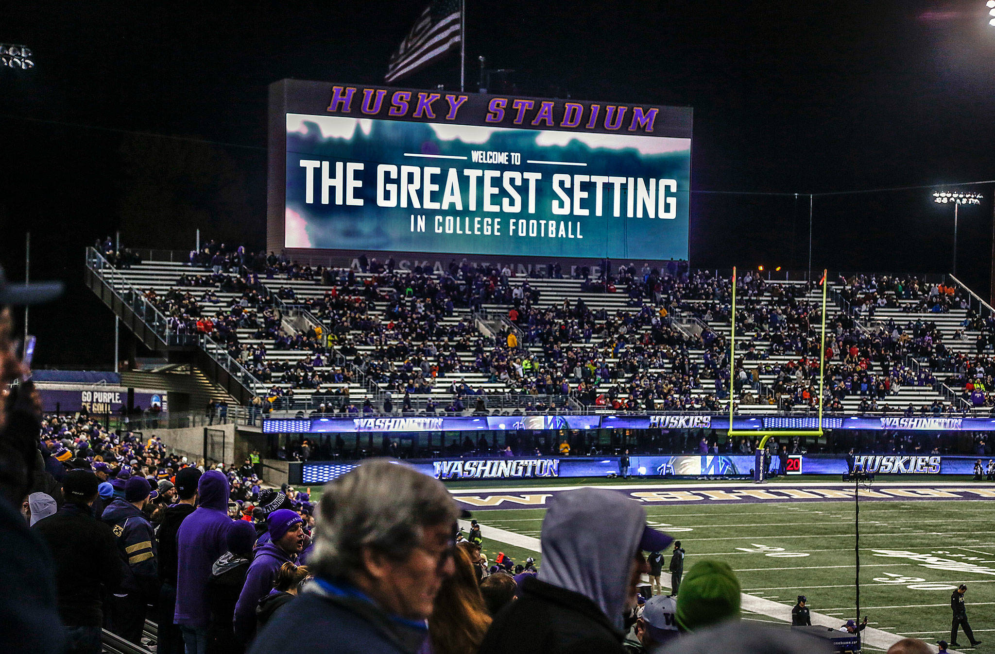The Lake Washington view from the “Greatest Setting in College Football” is behind the sign that says it is so. The setting is lost in the blackness, so folks visiting from Salt Lake City to support their Utes last Saturday night had to take our word for it. (Dan Bates / The Herald)