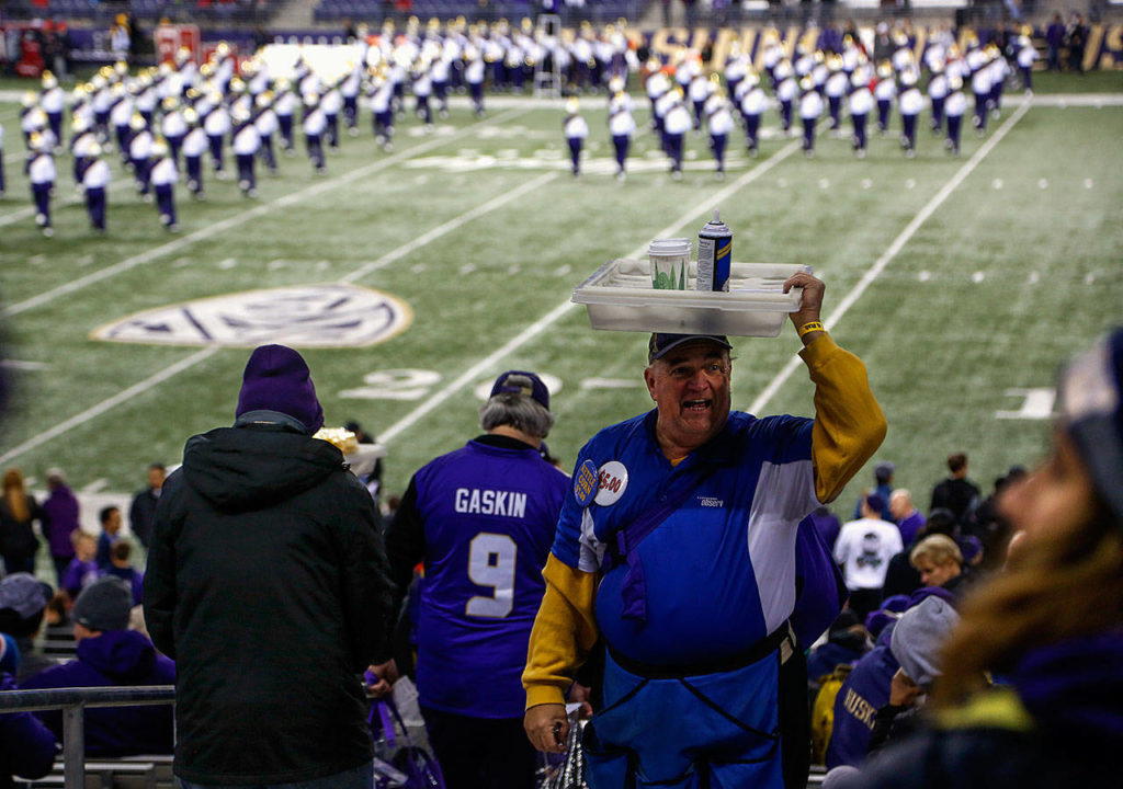 Hot chocolate and hand warmers might not atone for the ratio of night games to day games Husky fans have endured this season. (Dan Bates / The Herald)
