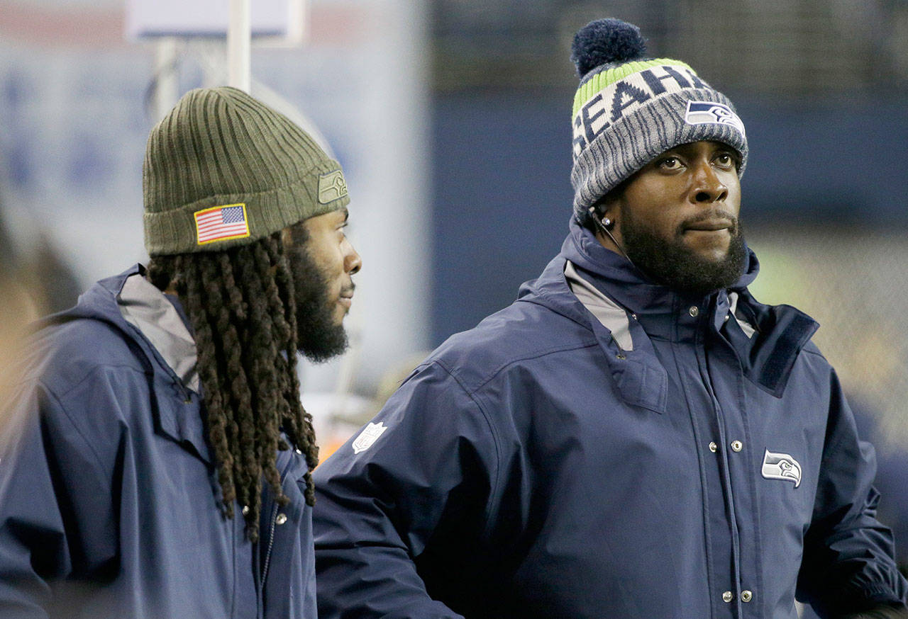 Two-thirds of the core of Seattle’s Legion of Boom, Richard Sherman (left) and Kam Chancellor, stand on the sidelines late in the Seahawks’ 34-31 loss to Atlanta on Monday in Seattle. (AP Photo/Ted S. Warren)