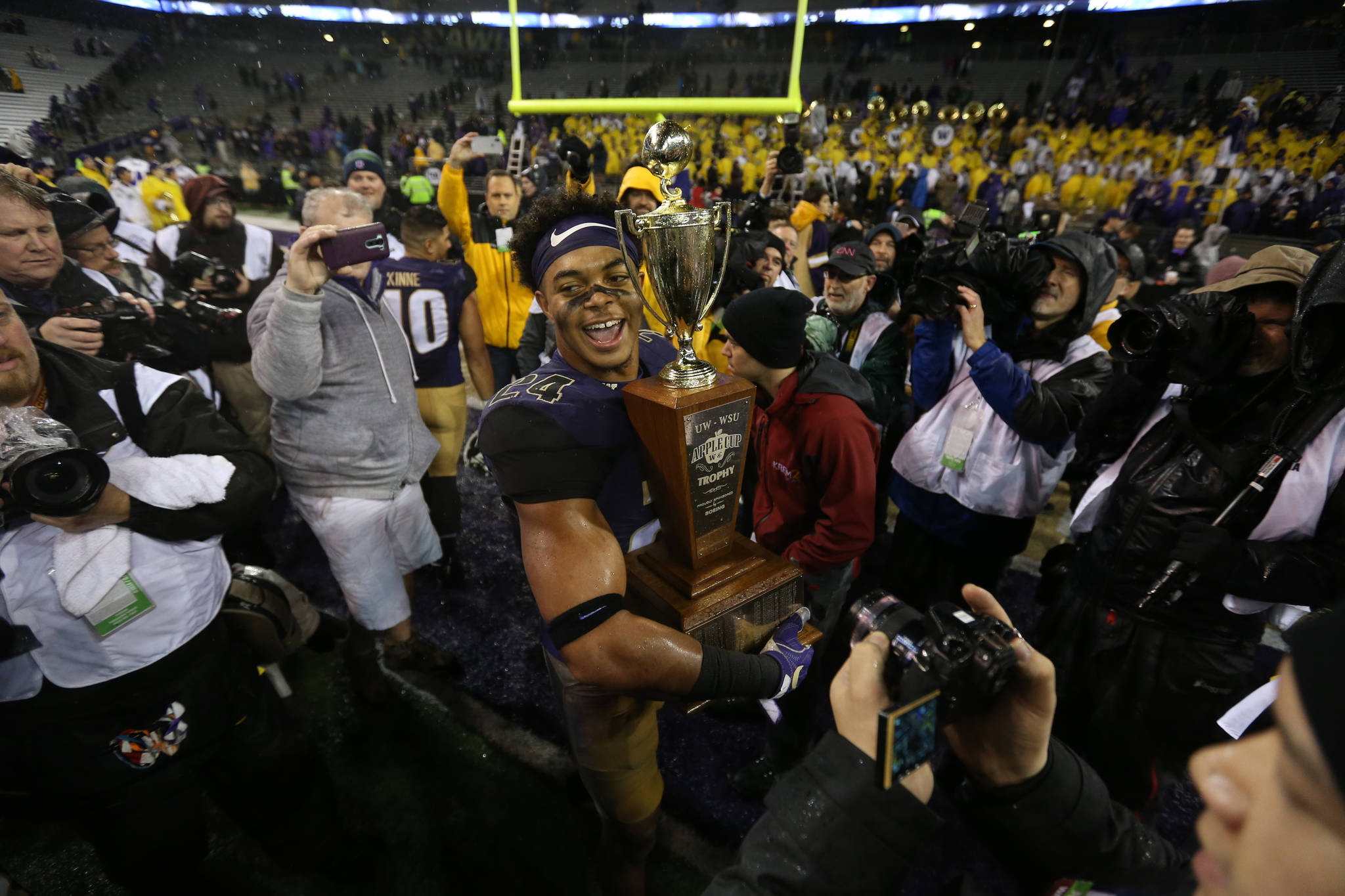 Washington Huskies defensive back Ezekiel Turner holds the Apple Cup trophy after the Washington State Cougars lost to the Washington Huskies 41-14 at Husky Stadium in the 110th Apple Cup on Saturday, Nov. 25, 2017 in Seattle, Wa. (Andy Bronson / The Herald)