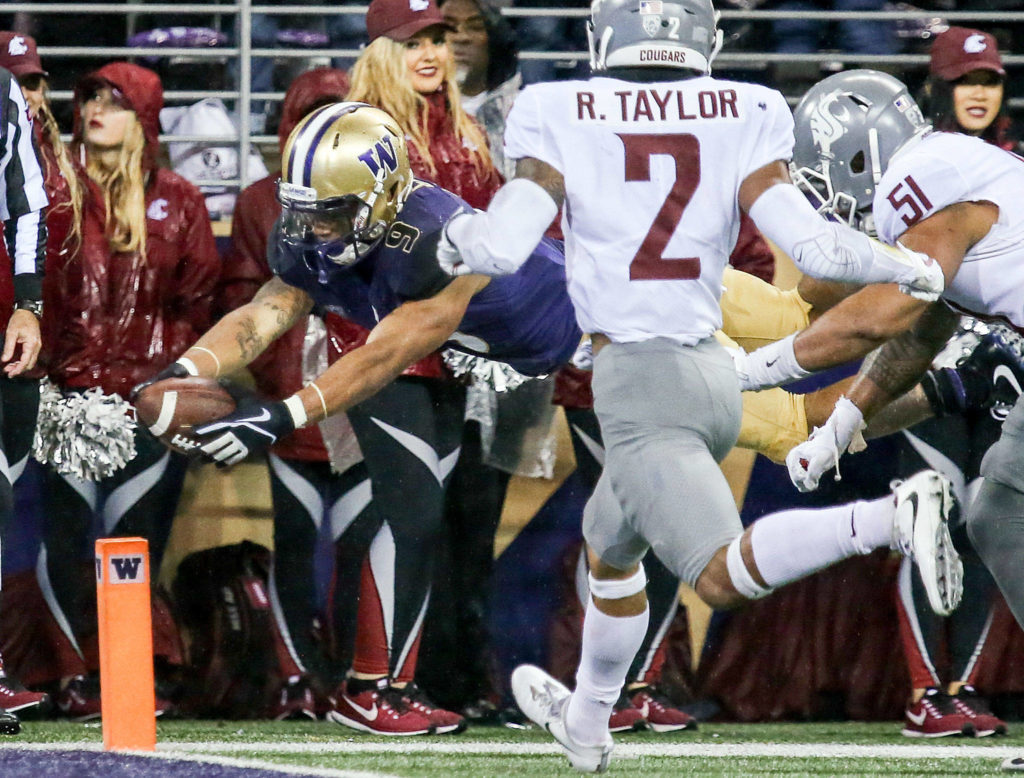 Washington Huskies running back Myles Gaskin dives for the pylon and a touchdown in the third quarter Saturday night during the 110th Apple Cup at Husky Stadium in Seattle November 25, 2017. Washington won 41-14. (Kevin Clark / The Herald)
