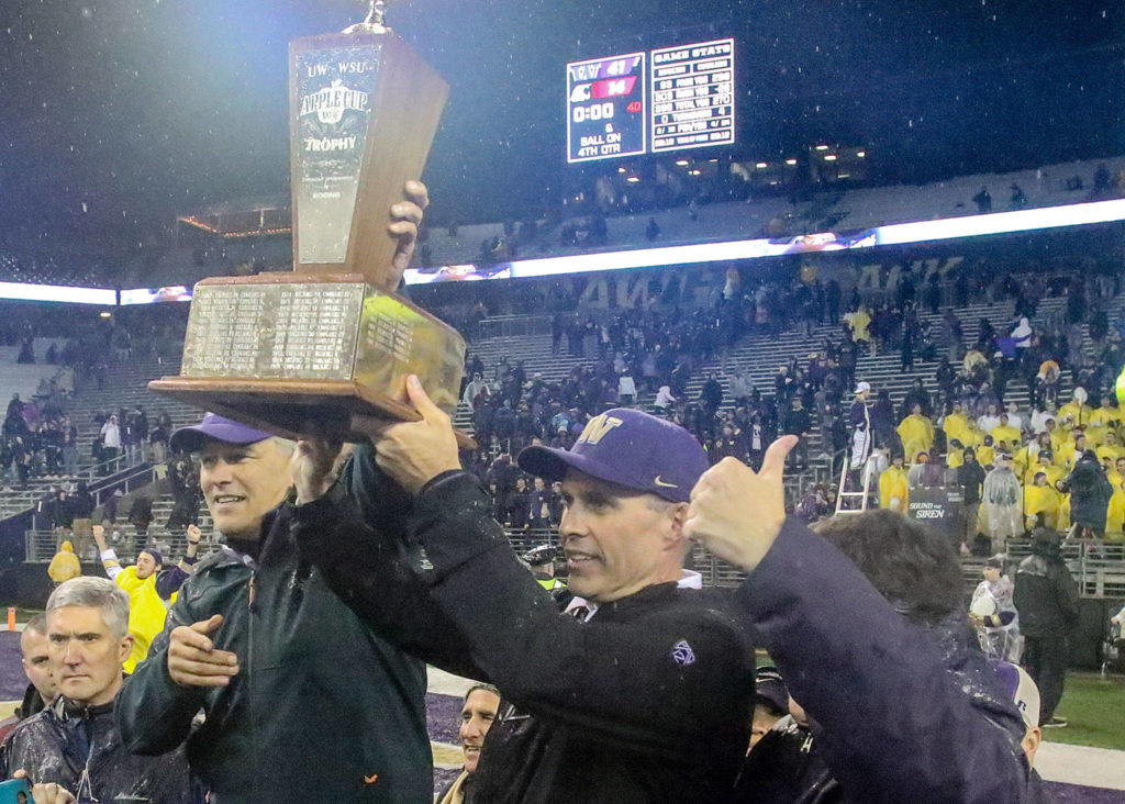 Gov. Jay Inslee, left to right, celebrates with Husky head coach Chris Petersen and UW President Ana Mari Cauce the win Saturday night during the 110th Apple Cup at Husky Stadium in Seattle November 25, 2017. (Kevin Clark / The Herald)
