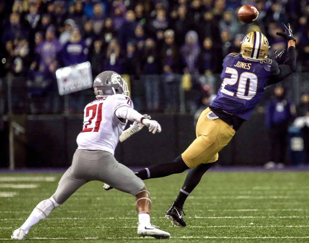Washington Huskies wide receiver Ty Jones makes a catch with Washington State Cougars cornerback Marcellus Pippins trailing Saturday night during the 110th Apple Cup at Husky Stadium in Seattle November 25, 2017. Washington won 41-14. (Kevin Clark / The Herald)
