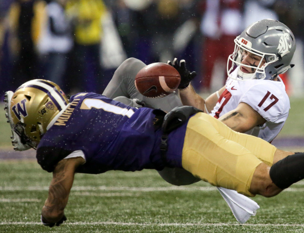 Washington Huskies defensive back Byron Murphy tackles Washington State Cougars wide receiver Kyle Sweet and forces a fumble Saturday night during the 110th Apple Cup at Husky Stadium in Seattle November 25, 2017. Washington won 41-14. (Kevin Clark / The Herald)
