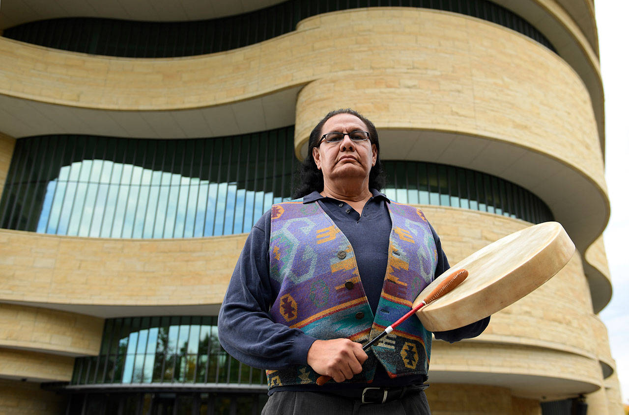 Dennis Zotigh poses outside the National Museum of the American Indian in Washington, Friday, Nov. 3, 2017. Many tribes even have their own national anthems known as flag songs that focus on veterans. They’re popular among Plains tribes from which the modern powwow originated, said Zotigh of the Smithsonian National Museum of the American Indian. Powwows are social gatherings, generally with competitive dancing. (AP Photo/Susan Walsh)