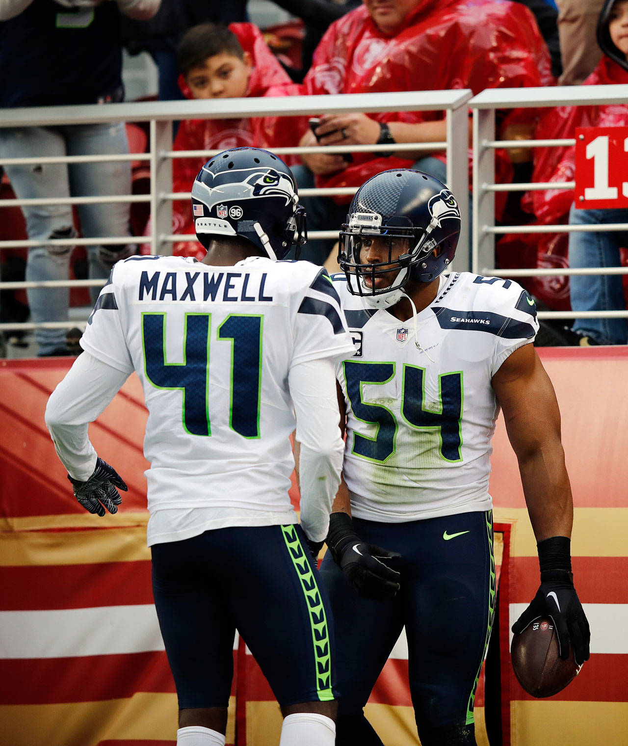 Seahawks middle linebacker Bobby Wagner (54) celebrates with teammate Byron Maxwell after intercepting a pass in the first half Sunday. (AP Photo/John Hefti)