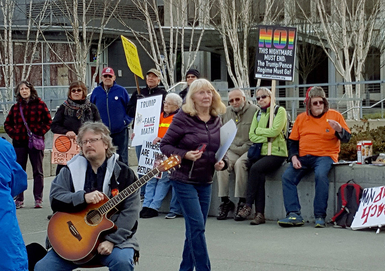 A few dozen protesters from SnoCo Indivisible and affiliated progressive groups gathered in downtown Everett on Monday to protest a Republican-backed tax bill and President Donald Trump.