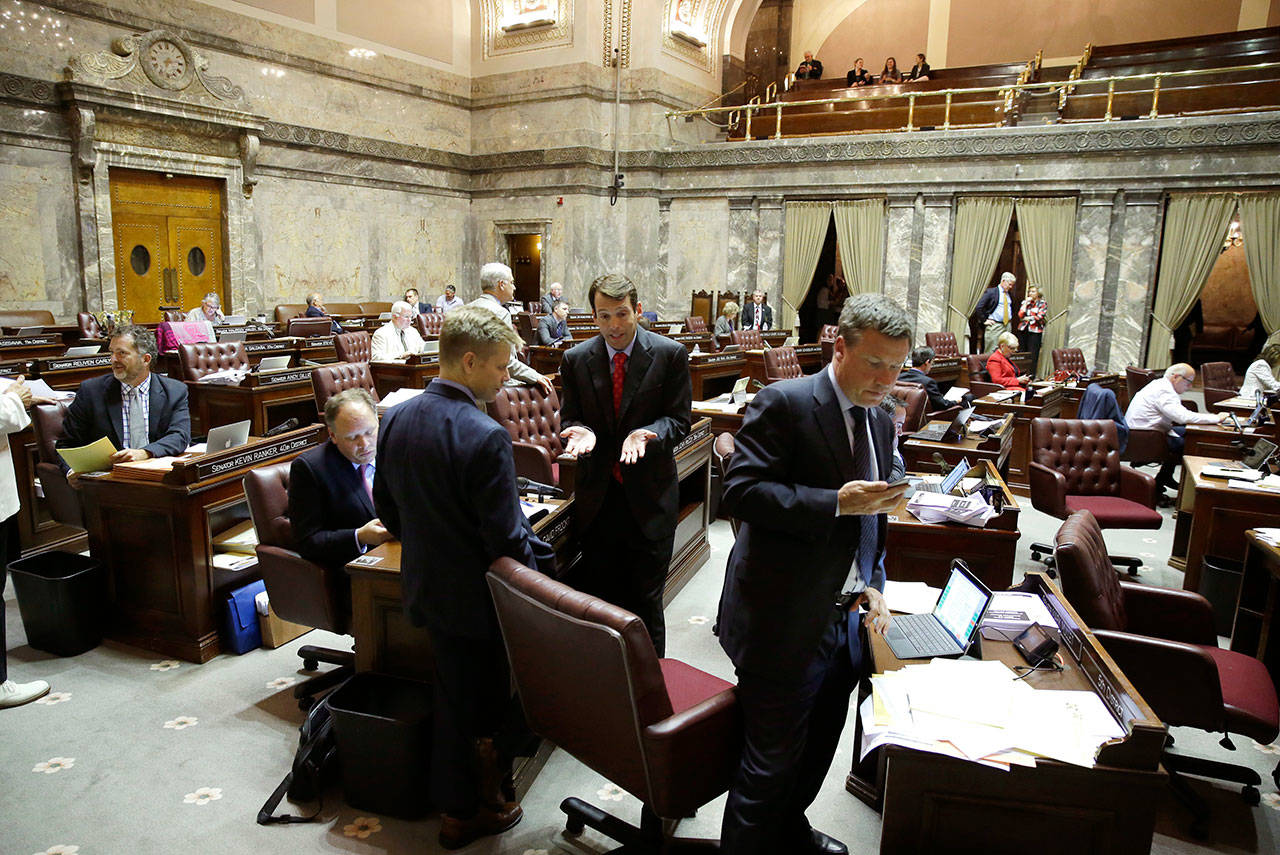 The public gallery is visible above the Senate floor at upper right in the Capitol in Olympia in this photo from June. All firearms will be banned from the public galleries above the Washington Senate floor starting next session, even concealed weapons carried with a permit. Lt. Gov. Cyrus Habib issued the order, saying his goal is to create a safe environment in the chamber. (Ted S. Warren / Associated Press file photo)