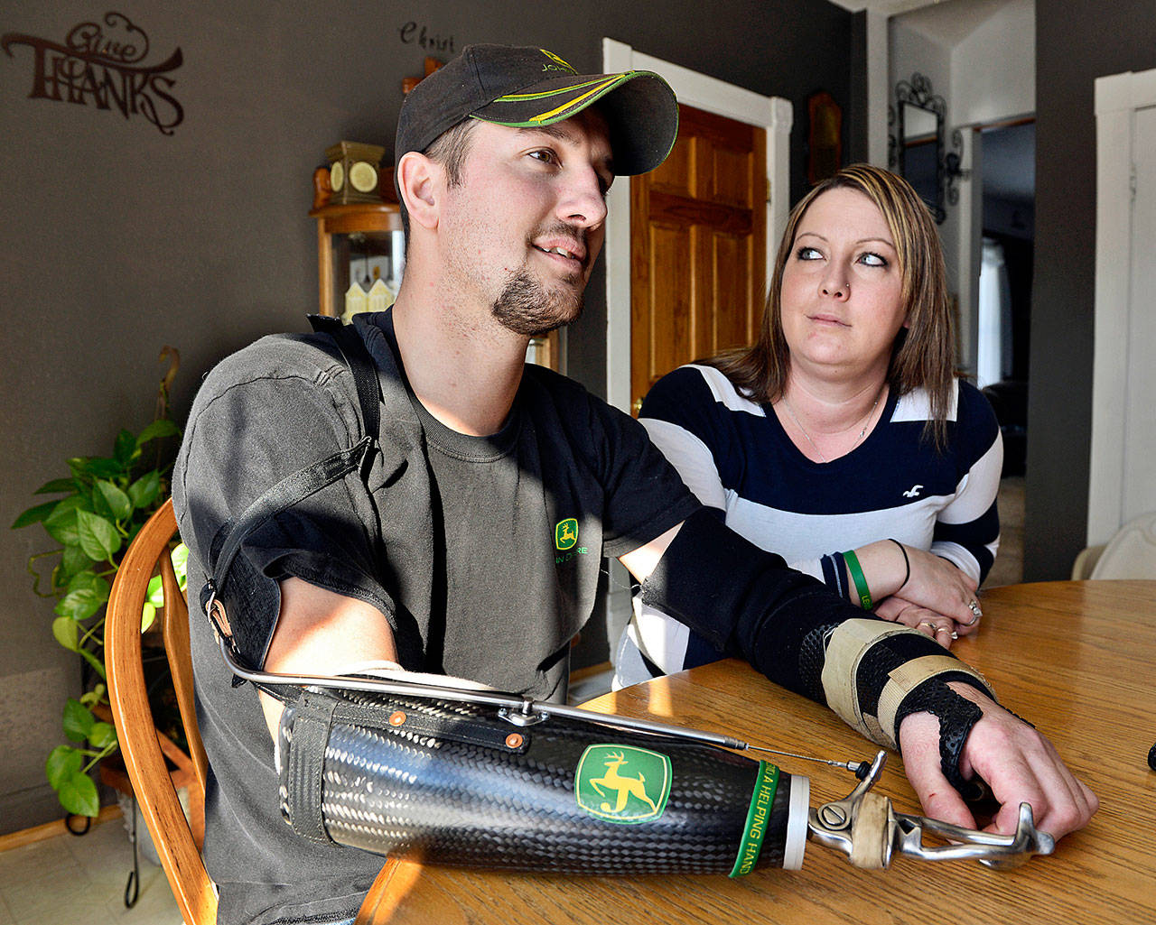 Little Falls, Minnesota, resident Jamie Houdek, with his wife, Lisa, at his side, talks in 2014 about his recovery after he lost his right hand to a corn picker in 2013 on the 60-acre hobby farm where he raises beef cattle. (Kimm Anderson / St. Cloud Times)
