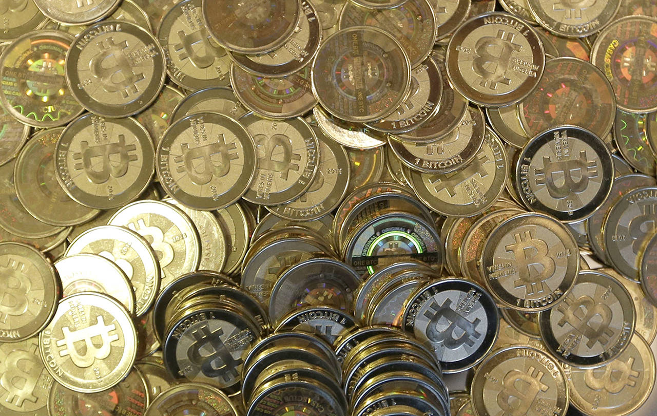 This 2013 photo shows bitcoin tokens at 35-year-old software engineer Mike Caldwell’s shop in Sandy, Utah. (AP Photo/Rick Bowmer, file)