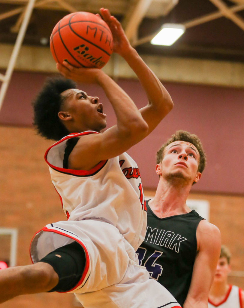 Mountlake Terrace’s Connor Williams (left) attempts a shot with Kamiak’s Daniel Sharpe defending during a game Nov. 29, 2017, at Mountlake Terrace High School. The Hawks won 63-59. (Kevin Clark / The Herald)
