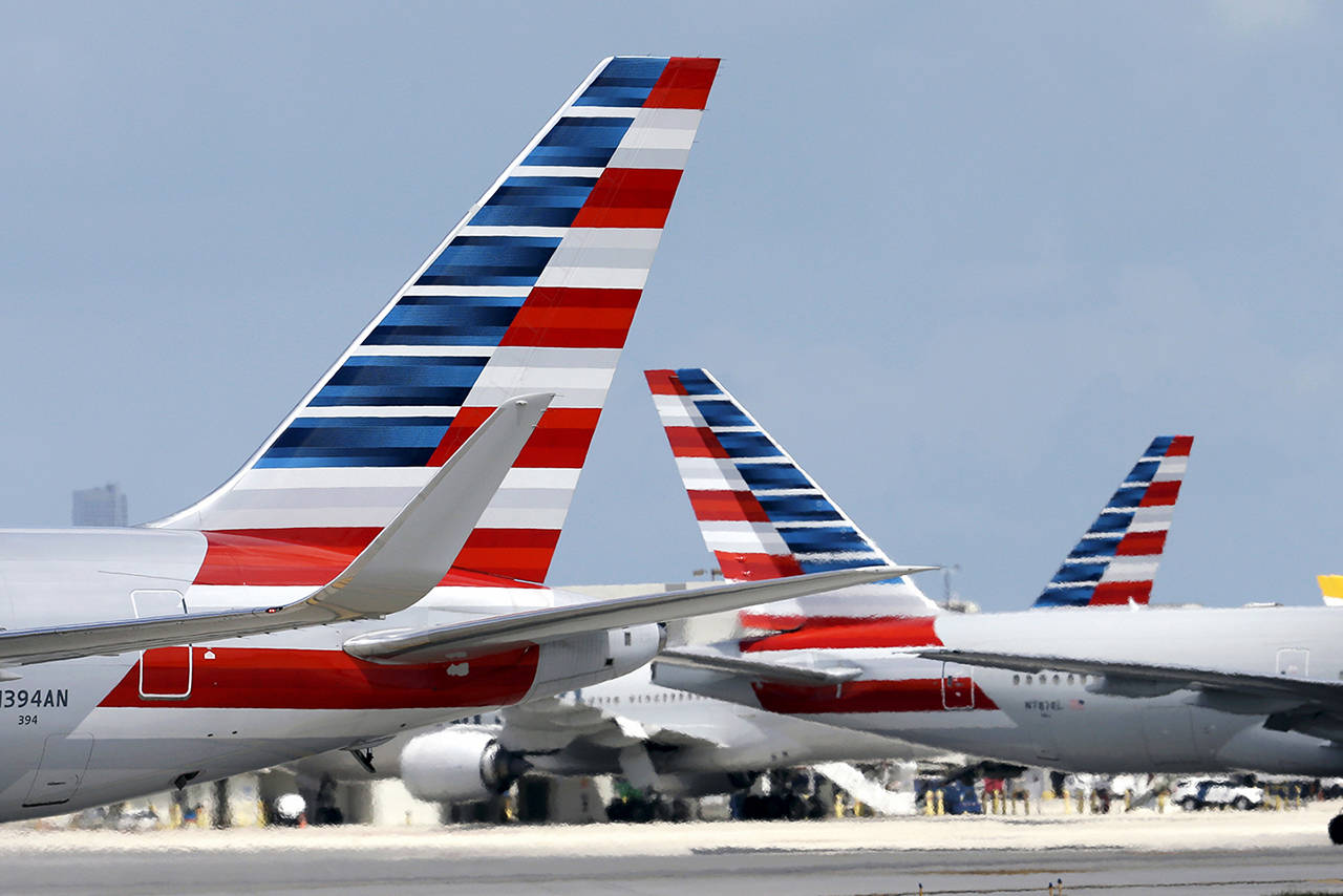 In this 2015 photo, American Airlines jets taxi at Miami International Airport, in Miami. (AP Photo/Lynne Sladky, File)