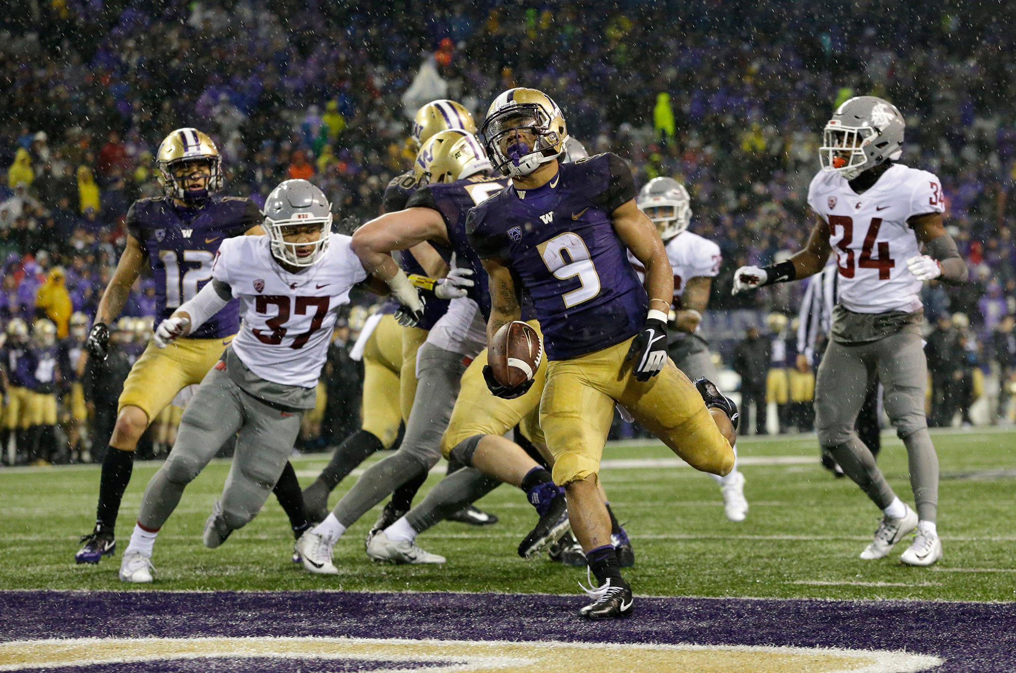 Washington running back Myles Gaskin (9) rushes for a touchdown against Washington State in the second half of the Apple Cup on Nov. 25, 2017, in Seattle. (AP Photo/Ted S. Warren)