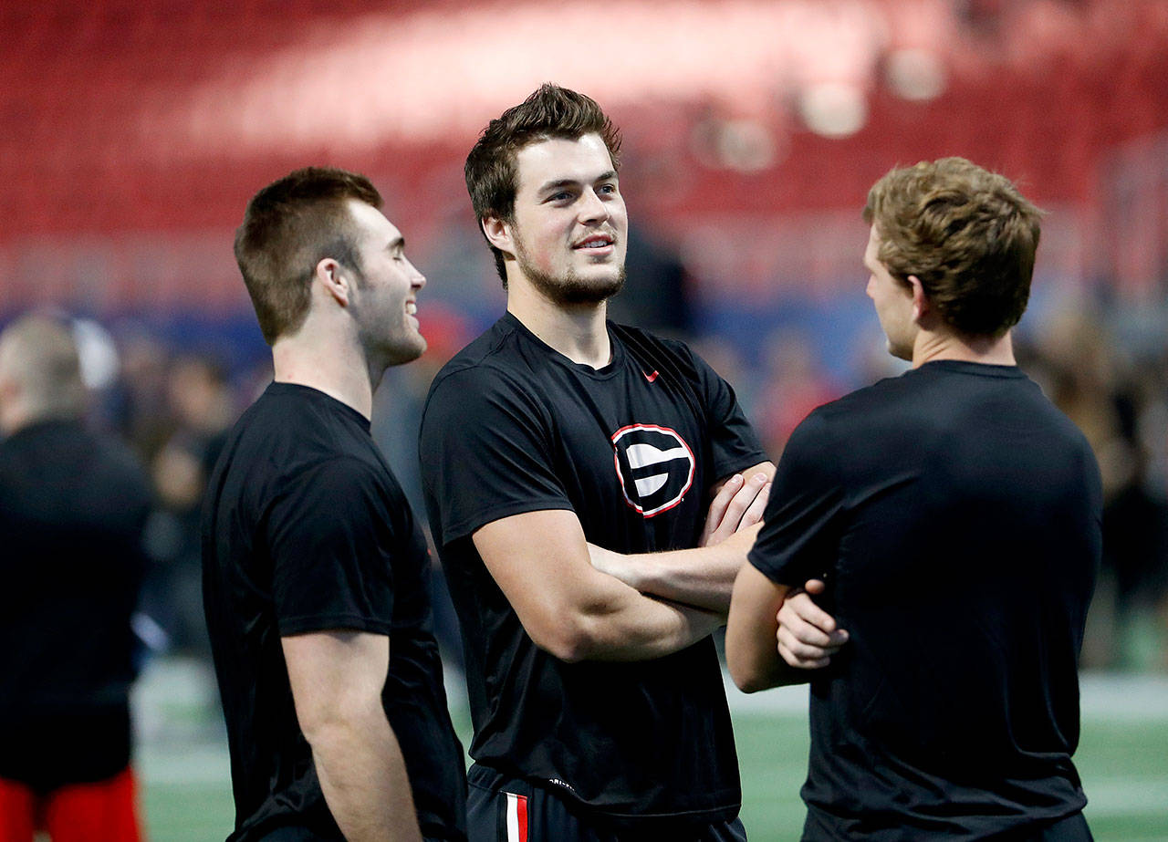 Georgia quarterbacks Jake Fromm (left) and Jacob Eason, a Lake Stevens alum, stand on the field during a walkthrough with teammates ahead of the Southeastern Conference championship game on Dec. 1, 2017. (AP Photo/David Goldman)