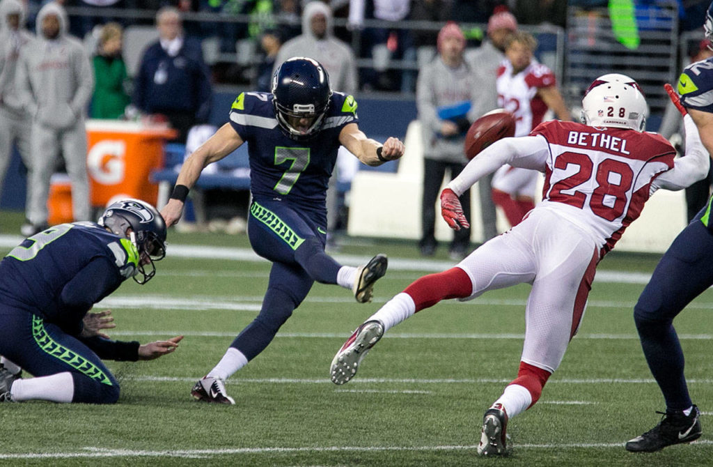Seahawks kicker Blair Walsh kicks and misses the field goal with Seahawks punter Jon Ryan, left, hold and Cardinals corner back Justin Bethel closing Sunday afternoon at CenturyLink Field in Seattle on December 31, 2017. Seattle lost 26-24. (Kevin Clark / The Daily Herald)

