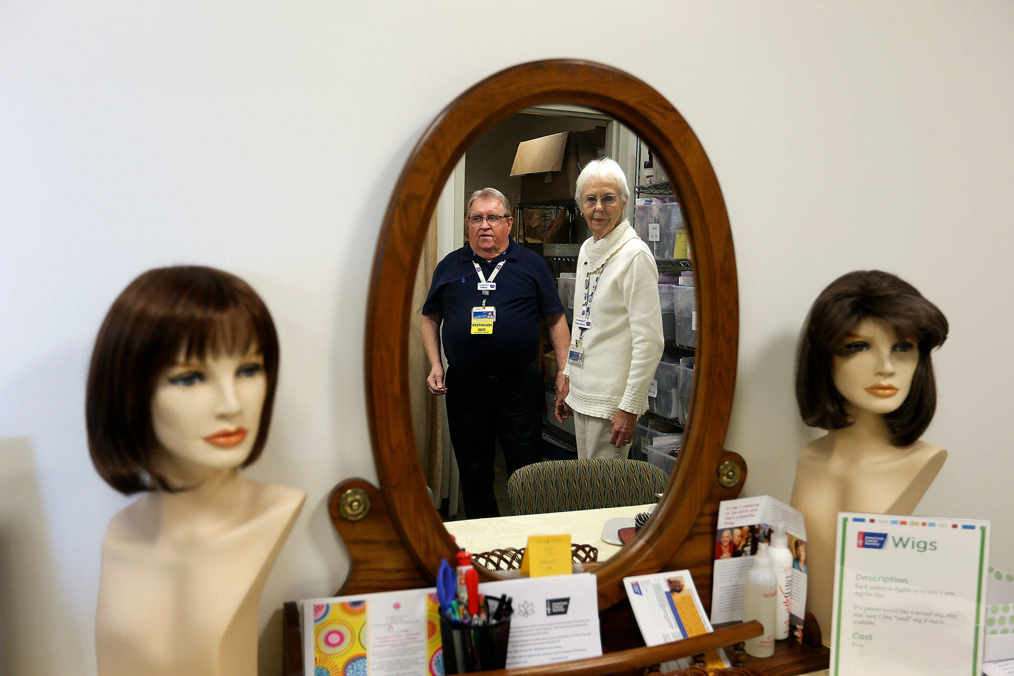 American Cancer Society volunteern Larry Behan and Margaret Miner look over Spirit Healing Boutique, where cancer patients can get wigs, at the Cancer Resource Center at Providence Regional Medical Centeron on Oct. 31 in Everett. (Andy Bronson / The Herald)