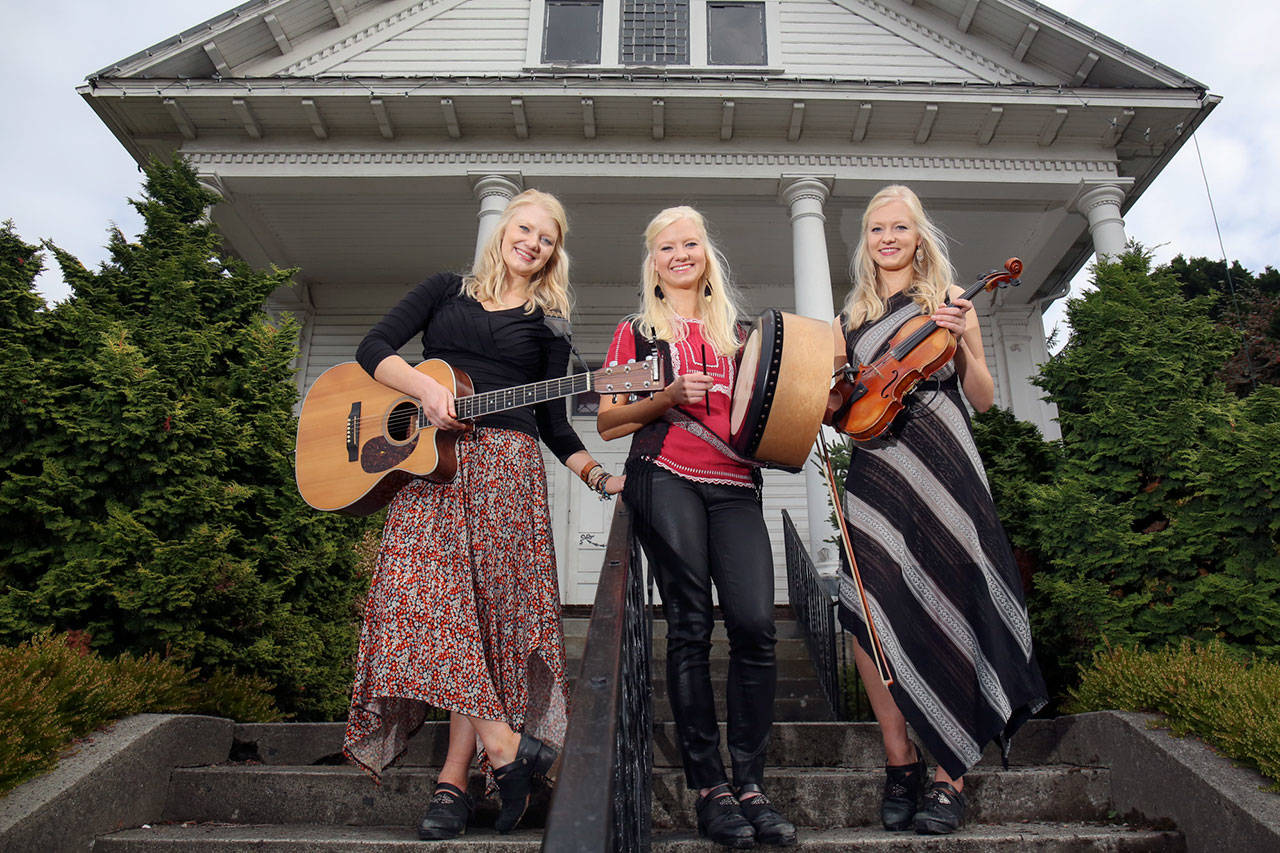 Out in front of the Thumbnail Theater in Snohomish, the sisters from left, Greta, Solana and Willow pause before a concert there. (Kevin Clark / The Herald)