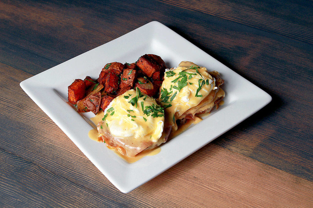 It’s hard to go wrong with eggs Benedict and sweet potato home fries, served for brunch at Revolve True Food in Bothell. (Cherelle Ashby)

