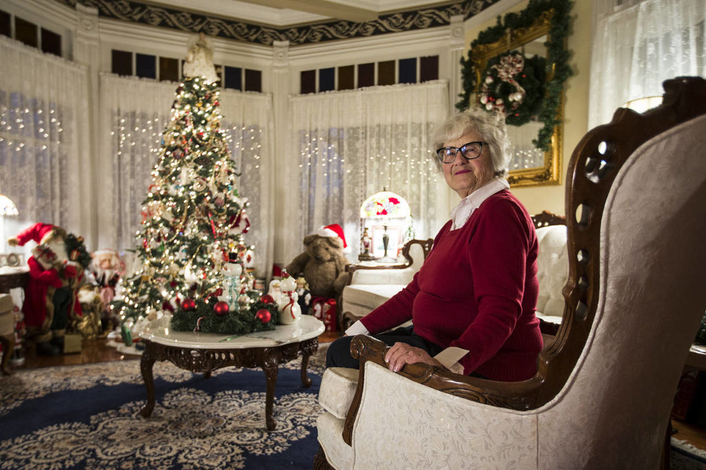 Lisa Pickford sits in the living room of her home in Snohomish. Pickford and her husband, Stew, fill their home with Christmas decorations each year. (Ian Terry / The Herald)
