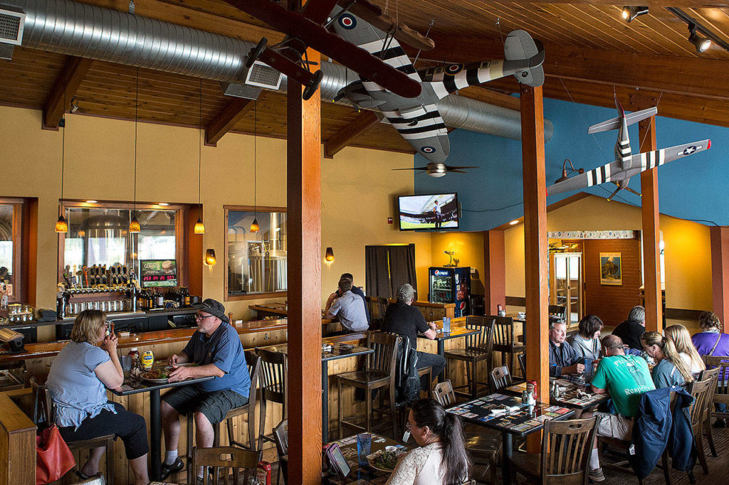 Flyers Restaurant and Brewery’s dining area is adorned with model planes as well as a glass wall that looks through to brewing equipment. (Ian Terry / Herald file)
