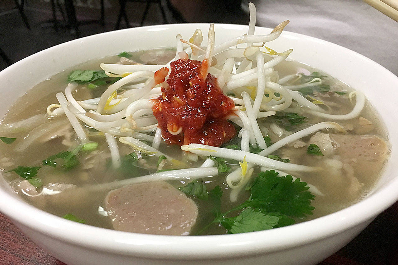 Pho, a Vietnamese beef broth noodle soup, is a go-to option at Yummy Banh Mi in Everett. This large bowl ($8.99) includes rare steak, brisket, meatballs and tendon with rice noodles, cilantro, lime, bean sprouts and Thai basil. (Ben Watanabe / The Herald)