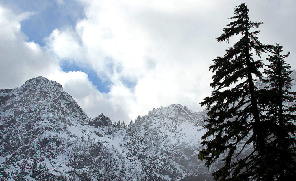 Hikers need to be extra prepared when hiking in late fall, especially because of early snow. In this Nov. 3, 2015, file photo, snow covers mountains in this view from the Snow Lake hiking trail above Snoqualmie Pass in Washington state. (AP Photo/Ted S. Warren, File)
