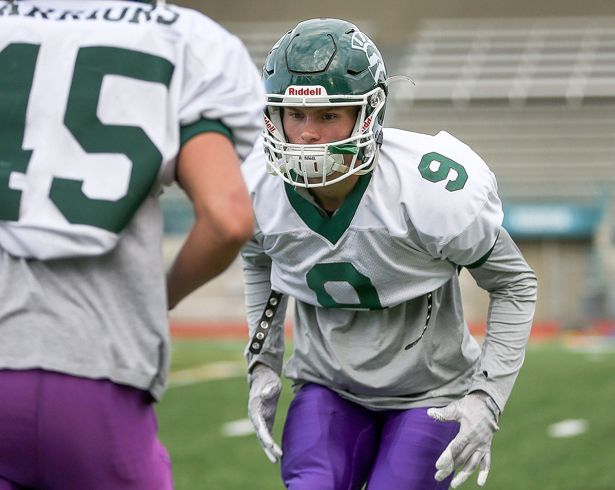 Noah Becker, defensive back, eyes the ball held by Jack Kramer during drills Wednesday afternoon at Edmonds-Woodway High School in Edmonds on October 11th, 2017. (Kevin Clark / The Herald)