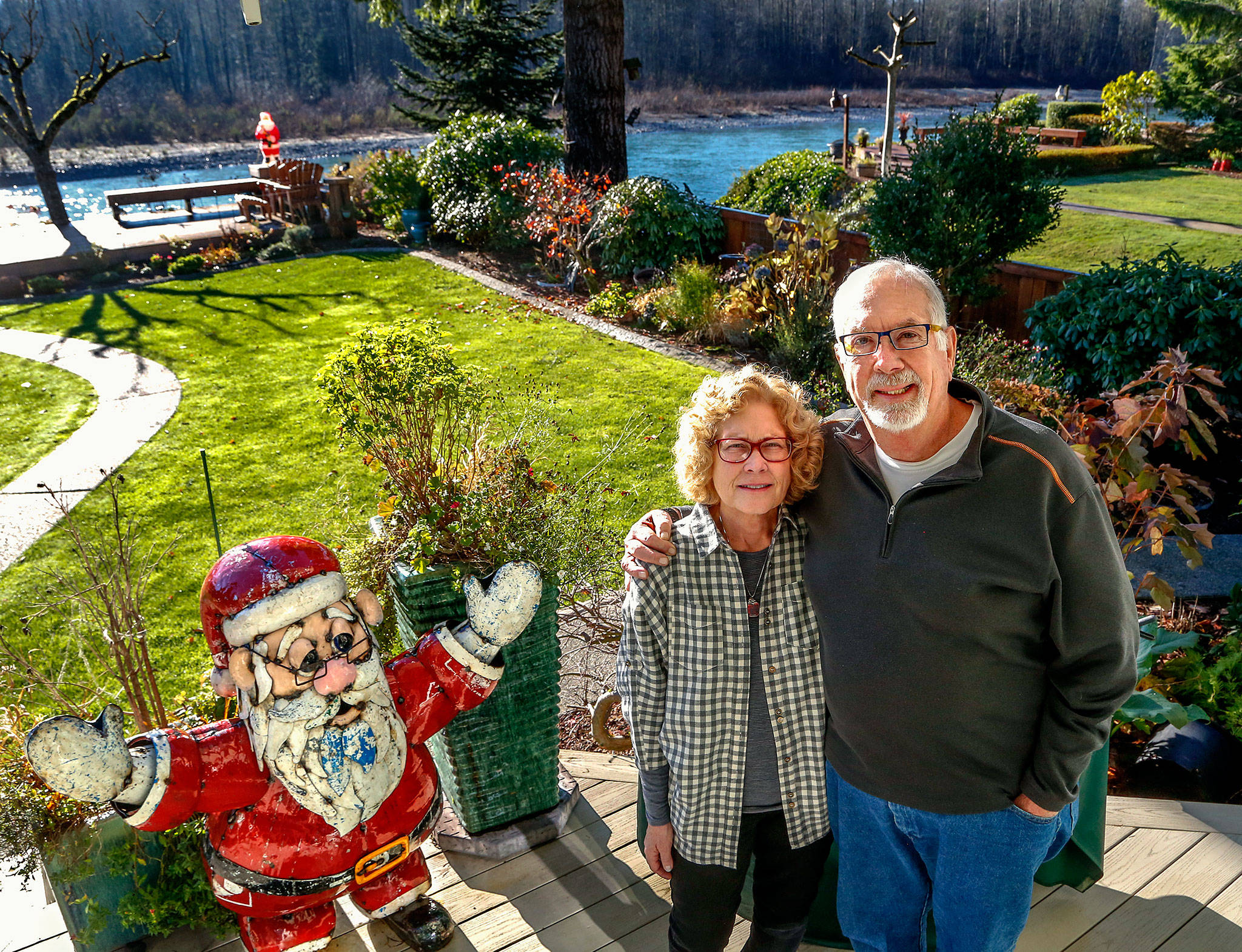 Gerry and Bonnie Gibson enjoy the morning sun from their back yard on the Skykomish River in Sultan on Tuesday. The Gibsons never planned to spend their retirement installing smoke alarms in homes, but they have been helping the Red Cross do exactly that since Jan. 8, 2016, when a house fire took the life of their son, Greg “Gibby” Gibson, 36, a musician, and his dog, Nino. His death could have been prevented, Gerry said, with a smoke alarm. (Dan Bates / The Herald)